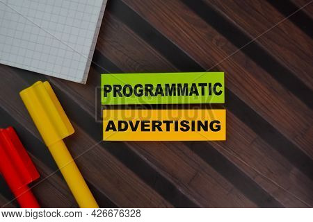 Programmatic Advertising Write On Sticky Notes Isolated On Wooden Table.