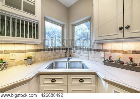 Corner Vanity Sink Inside A Kitchen With Granite Top
