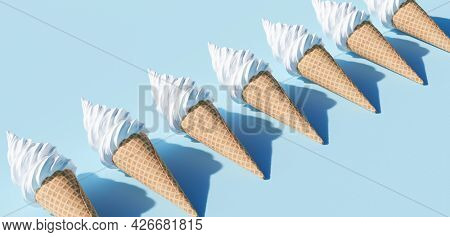 Soft serve ice cream in a cone on blue background 3D illustration