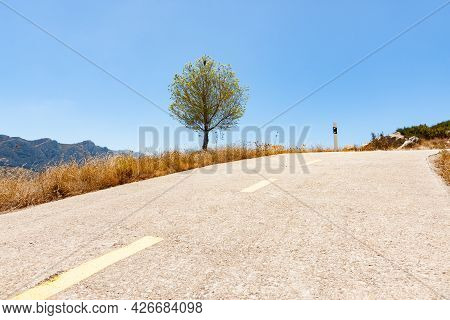 Road Through Coll De Rates Uphill Information Road Winding Through Mountains Toward To Rock Outcrop 