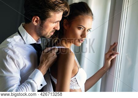 Romantic Couple Being Intimate And Sensual In Bedroom