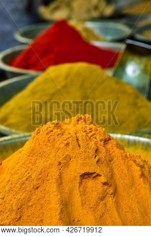Turmeric curcuma powder and chili powder in spices market in India. Sardar Market, Jodhpur, Rajasthan, India