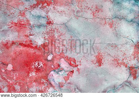 Wall With The Red Whitewash Falling Off Fragment With Cracks As A Background Texture. Old Paint On T