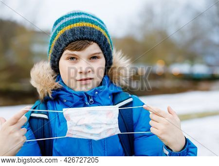 Kid Boy Wearing Ffp Medical Mask On The Way To School. Child Backpack Satchel. Schoolkid On Cold Aut