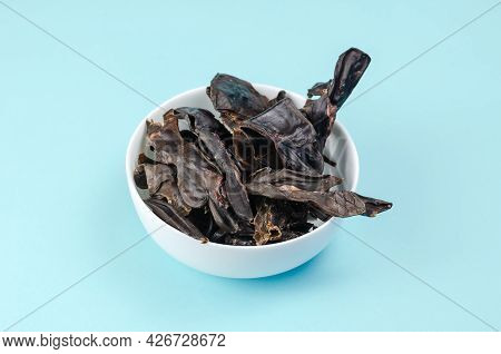 Training Treats For Pets On Blue Background. Natural Air Dried Dog Treats In A White Ceramic Bowl. Y