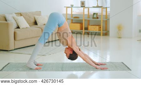 Attractive yogist doing wellness practice on the floor