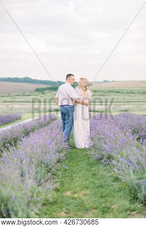 Mature Couple, Celebrating Their Wedding Anniversary, Enjoy A Moment Of Happiness And Love, Walking 