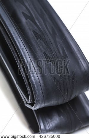 Closeup Of New Folded Road Bike Tyre Over White Background. Vertical Image