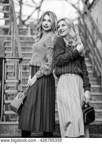 Completing Each Other. Matching Outfits. Women Sisters Outdoors Stairs Background. Vogue Concept. Gi