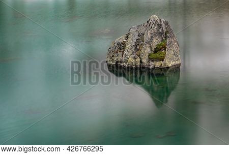 Long Esposure Of A Rock In The Lake Of Mountain Pass Julierpass In Switzerland