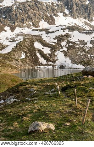 Snowy Rocks And The Lake At The Julier Mountain Pass In Switzerland