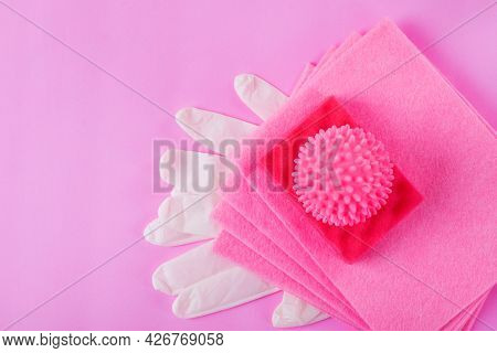 Pink Cleaning Set. Laundry Ball, Rag, Foam Rubber Sponge And Latex Gloves On Pink Background. Flat L