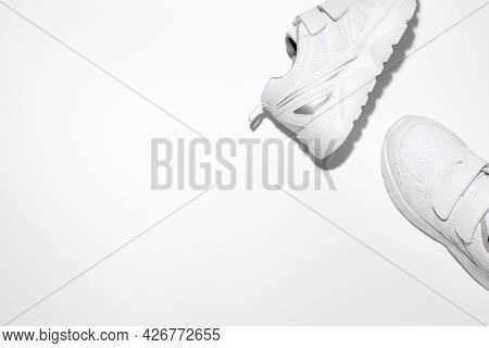 Mock Up Two White Running Shoes On The Side With Free Space For Text Isolated On A White Background