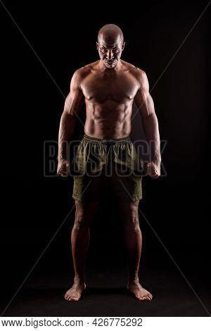 Muscular Adult Male Standing Looking At Camera With Serious Expression