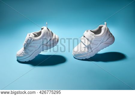 Two White Girly Flying In The Air Sneakers Simulate Walking Or Running