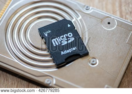 Close-up Of A Micro Sd To Sd Adapter On A Hard Disk