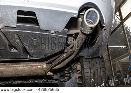 The Exhaust System In The Car Seen From Below, Visible End Silencer And Wheel, The Car Is On The Lif