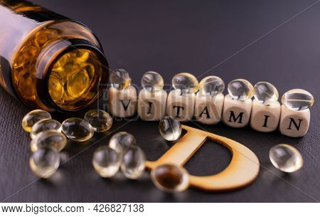 Lots Of Vitamin D3 Gel Capsules On A Black Background. Selective Focus.