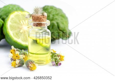 Bergamot Fruit Extract Aroma Gel In Glass Bottle Over Blur Fruit And Wil Grass Flower On White Backg