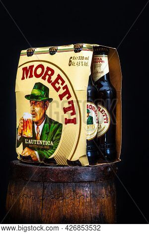 6 Pack Of Birra Moretti Beer On Wooden Barrel With Dark Background. Illustrative Editorial Photo Buc