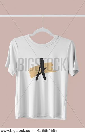 White t-shirt mockup hanging on a clothing rack