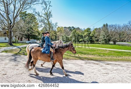 Williamsburg, Virginia, USA: 31st March 2021; Two men on horses in historical colonial Williamsburg