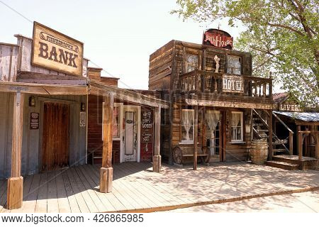 July 14, 2021 In Pioneertown, Ca:  Rustic Boardwalk In Front Of Historic Rustic Wooden Buildings Wit