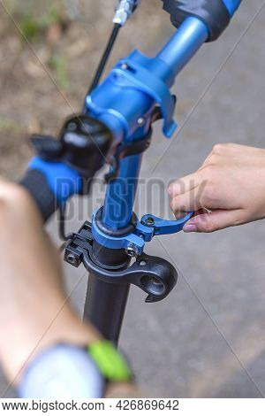 The Wheel Of A Scooter. Adjusting The Position Of The Scooter Steering Wheel. The Guy Adjusts The He