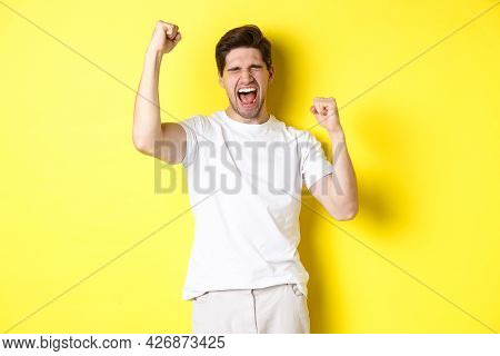 Excited Handsome Man Winning And Shouting For Joy, Raising Hand Up And Triumping, Achieve Goal, Stan