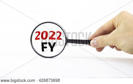 2022 Fy Fiscal New Year Symbol. Businessman Holds Magnifying Glass With Words '2022 Fy Fiscal Year' 