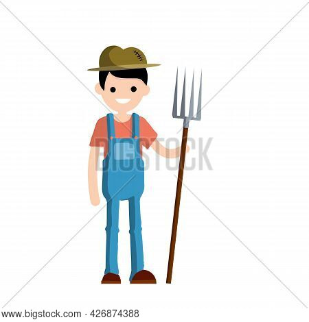 Man Farmer In Overalls With Fork In Hands. Rural Type Of Work. Production Of Natural Food In The Vil