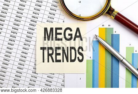 Business Concept. Top View Of Stiscker With Text Mega Trends On The Chart Background