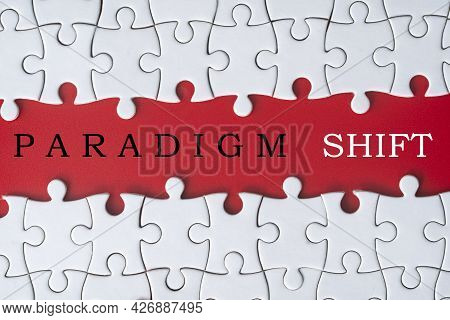 Business Concept. Jigsaw Puzzle With Text Paradigm Shift On Red Background. Selective Focus Point