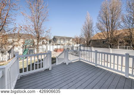 Deck Of A House With A View Of A Playground In The Backyard