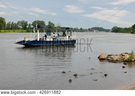 Arcen, The Netherlands - June 24, 2021: Small Ferry Crossing River Meuse Near Dutch Village Arcen