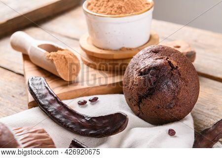 Chocolate Carob Cupcake Cooking With Carob Powder And Dried Carob Pods And Carob Powder In A Bowl Ov