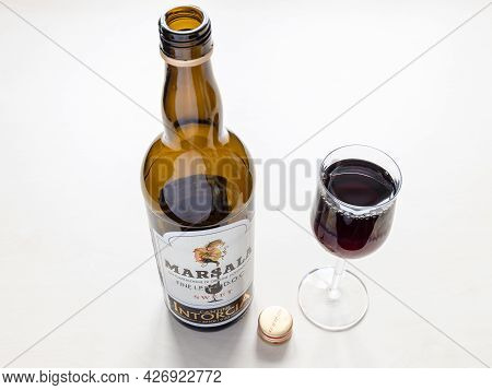 Moscow, Russia - June 10, 2021: Wine Glass And Open Bottle Of Sweet Marsala From Cantine Intorcia. M