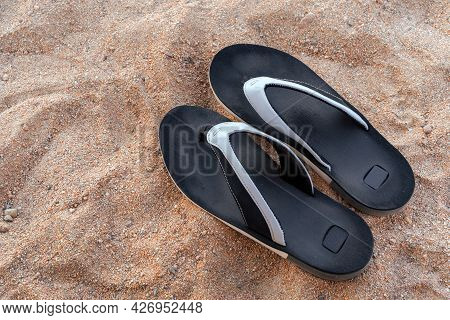 Mens Beach Shoes On The Sand. Black Flip-flops