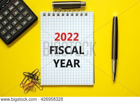 2022 Fiscal New Year Symbol. White Note, Words 2022 Fiscal Year On Beautiful Yellow Table, Paper Cli