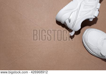 Mock Up Flat Lay Two White Sneakers On The Side In The Corner With Copy Space Isolated On A Beige Cr