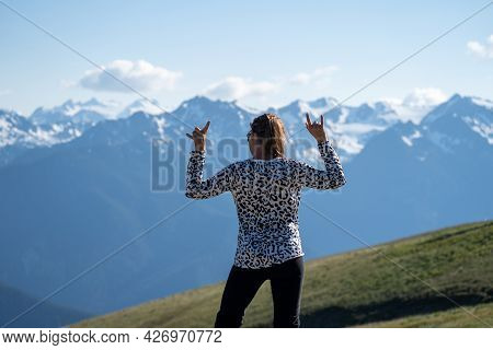 Young Adult Woman With Back Facing The Camera, Rocks Out And Headbangs At Hurricane Ridge In Olympic