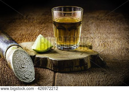 Glass Of Cachaça, A Brazilian Drink Distilled From Sugar Cane, Served With Lemon, Also Called Pinga,