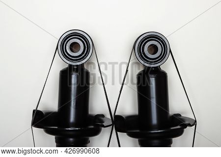 The Upper Mountings Of The Shock Absorbers For The Machine Lie On A Flat Surface. A Set Of Spare Par