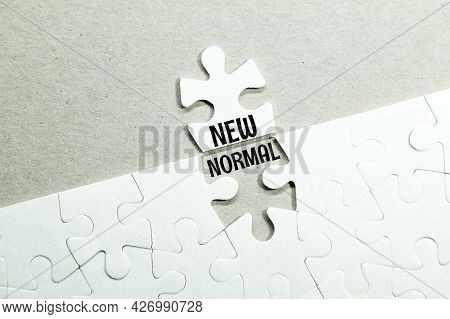 White Jigsaw Puzzle With The Word New Normal