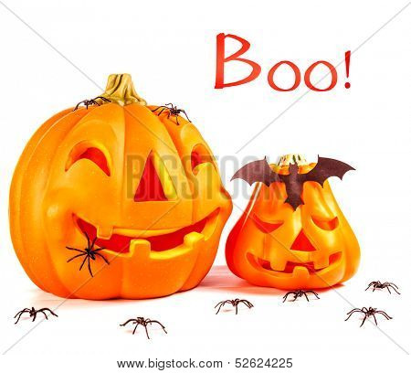 Traditional Halloween decoration, scary pumpkin face laughing with bat and spiders on head, isolated on white background, text space