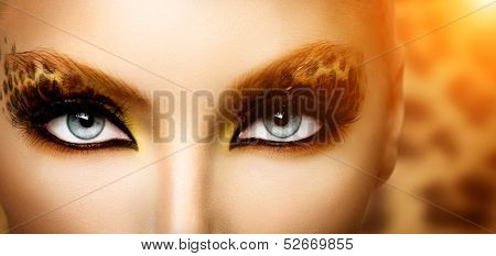 Make up. Beauty Fashion Model Girl with Holiday Leopard Makeup. Golden Wild Cat Eyes Make-up Eyeshadow. Beautiful Woman Face with Perfect skin. Animal Make up 