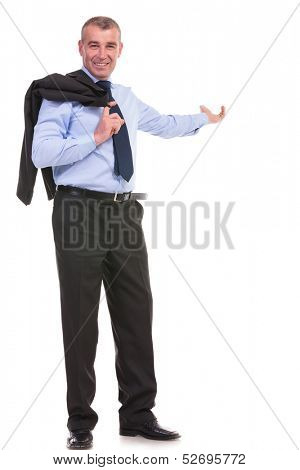 full length picture of a business man holding his jacket over his shoulder and presenting something in the back while smiling for the camera. on a white background