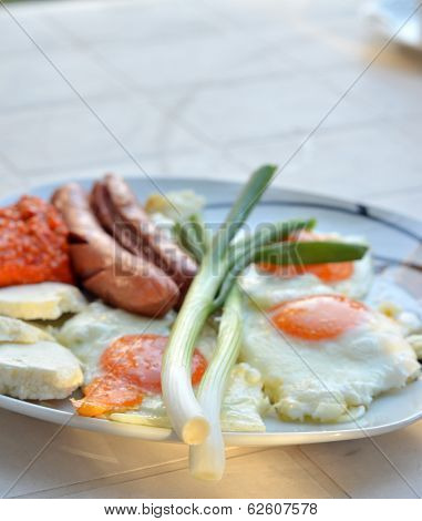 Appetizing breakfast with fried eggs  and fried sausages