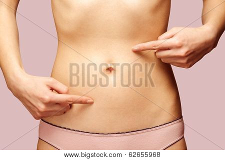 Woman Points To The Abdomen, Circle Arrows On The Stomach