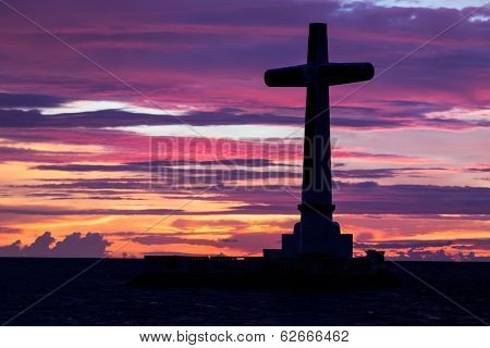 Catholic cross silhouette in the sunken cemetery at dusk, Camiguin island, Philippines